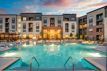 Resort-style swimming pool with sunning ledge, plunge pools, cabanas, and fire pit